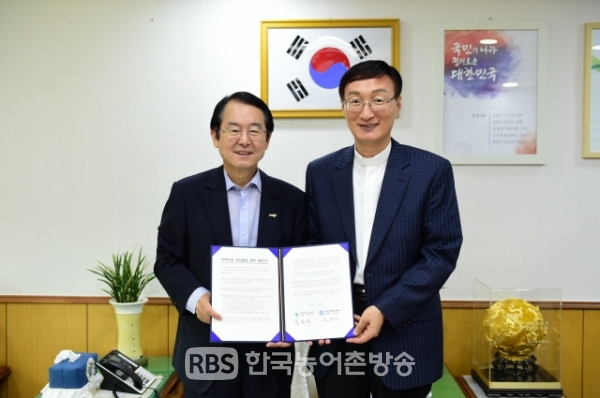 김종식 목포시장(사진, 왼쪽)과 목포카톨릭대학교 노성기 총장(사진, 오른쪽)이 '지역사회 공헌활동 업무협약'을 체결하고 함께 협약서를 들어보이고 있다.